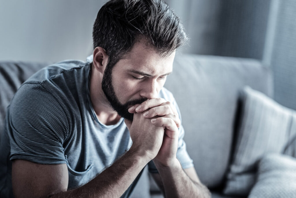 Man thinking about the signs of sex addiction