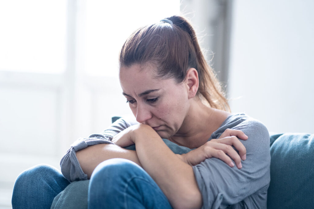 A woman contemplating emotional relapse